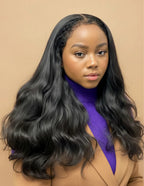 Model wearing Natural Black Raw Wavy Wig, 13x6 HD Lace frontal, 18-24 inch, effortless natural look, glueless comfortable fit, flowing bouncy waves.