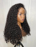Left side view of KAI Natural Black Kinky Curly Wig, 7x5 Lace, 4C Hairline, Human Hair, Voluminous Curls, Glueless, Trendy and Chic