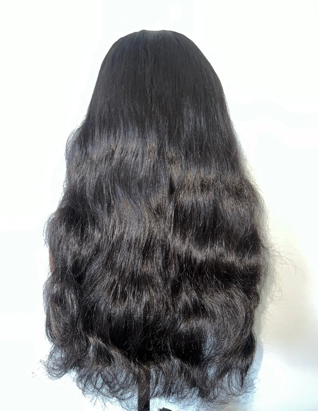 Back view of Natural Black Raw Wavy Human Hair Wig, 13x6 HD Lace, 18-24 inch, defined natural wave pattern, thick and healthy ends, no tangle, no shedding.