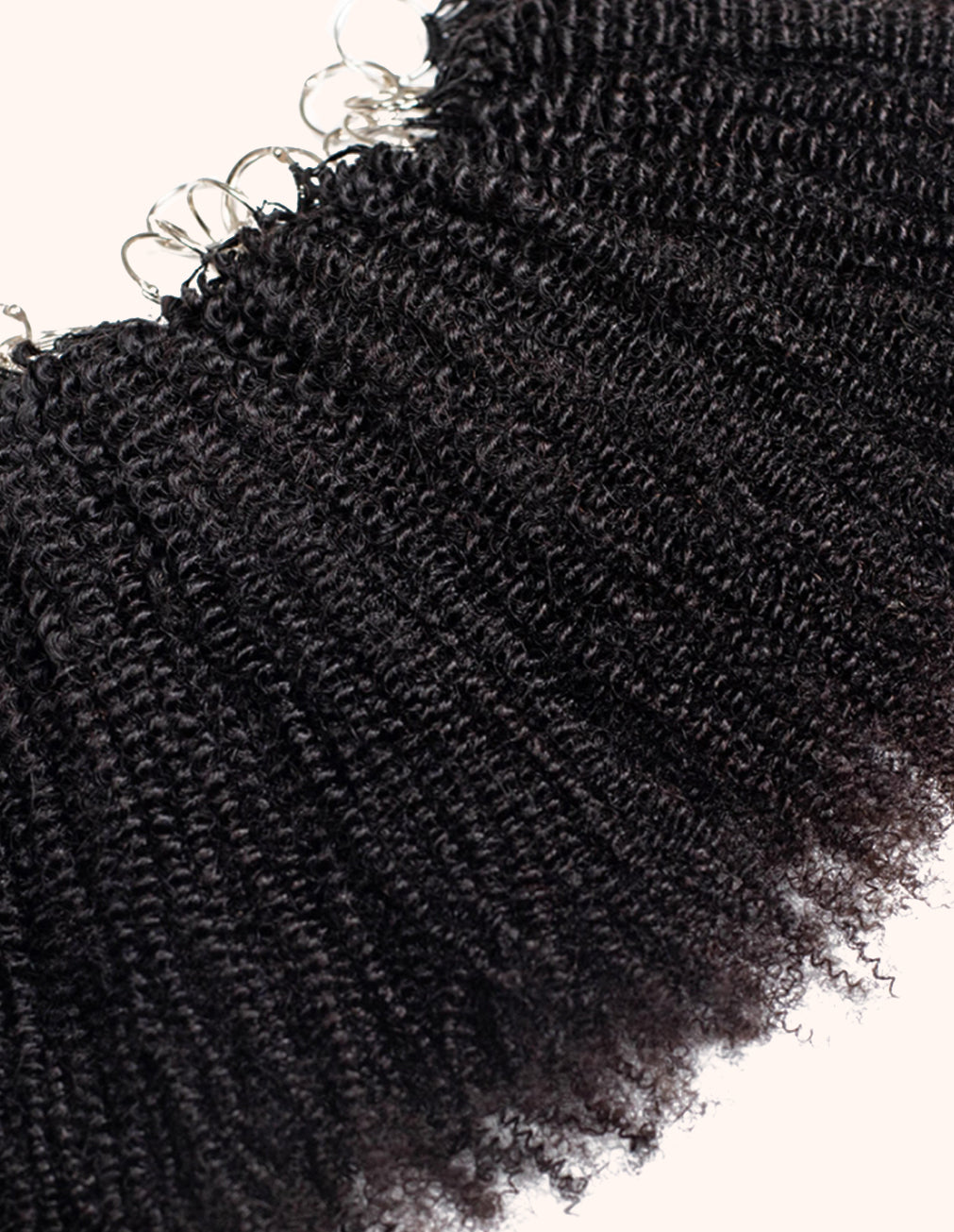 Close-up of black synthetic hair extensions on a white background